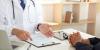 What income level allows access to France’s free or low-cost top-up insurance?