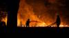 Holiday hotspot wildfire kills two firefighters as hundreds escape on boats