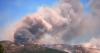 Tens of thousands of people flee raging wildfires in France, Spain, some escaping by boat