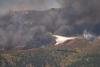 Thousands flee raging wildfires in France and Spain, some by boat