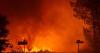Thousands flee fires in France, blazes merge in Spain
