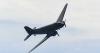 Historic wartime aircraft soars through the skies over beach