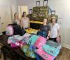 Steamatic drops off foster care bags at The CALL