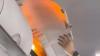 Terrifying moment passenger’s power bank bursts into flames in overhead locker on busy flight