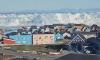 Moment enormous iceberg capsizes triggering tsunami-like waves off coastal town in Greenland