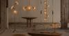 fiberglass shells and bronze skeletal forms shape sculptural light and furniture collection