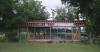 rhythmic timber and glass pavilion unfolds beneath pecan tree canopy in argentina