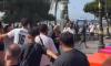 Moment angry locals waving Spanish flags chase migrants down the street after thousands invade enclave - as Army is called in