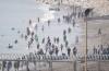 Nine bodies found after hundreds swim from Morocco to North African Spanish territory