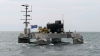 UK tests robot boat that can fly its own wired drone even in 14ft waves and stay at sea for weeks