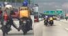 Cat clings to motorcyclist in Malaysia as he helps stranded delivery rider