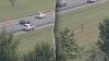 Ohio man fleeing police on foot leaps onto moving car, tries to take control before falling off: Police