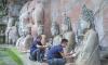 China's ancient murals and rock carvings under summer siege: Conservationists race to protect centuries-old heritage