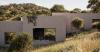 domestic archipelago of nine houses unfolds across portugal’s cork-oak landscape