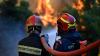 Greek firefighters hope to contain blaze near Athens as easing winds enable use of waterbombing aircraft