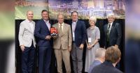 Governor Cox presents Intermountain Electronics with Utah Business of the Year Award
