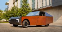 wrapped in a photovoltaic skin, this student-designed EV creates more energy than it uses