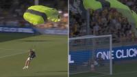 ‘I felt that’ – Fans wince as skydiver CRASHES into advertising boards in painful moment as football teams left stunned