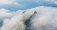 Rolling sea of clouds transforms central China's mountain peak into fairyland
