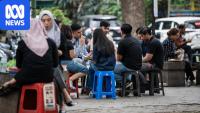 Inside this street food market are signs of a crashing currency