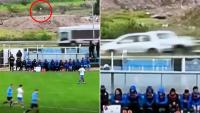 Fans left stunned as wayward clearance causes terrifying CAR CRASH on live TV during football match