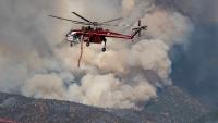 Wildfires spread across North America and Europe, two killed in Utah helicopter crash
