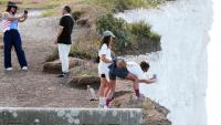 Oblivious tourists ignore warnings & pose for photos on edge of crumbling & ‘very fragile’ 400ft cliff in UK beauty spot