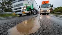 Traffic chaos as monster potholes leave cars wrecked on side of road