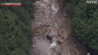 Stranded people cross makeshift bridge after mudflow cuts off central Japan road