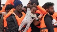 Months-old baby seen being hauled onto Channel migrant mega-dinghy to UK – as French police stand by and do nothing