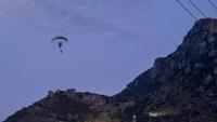 Shocking moment migrant PARAGLIDES into Europe and disappears just a day after another died attempting the same stunt
