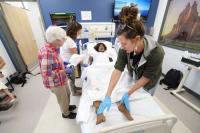 Southwest providers practice medicine on a manikin for the first rural health symposium at Fort Lewis College