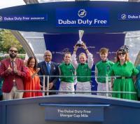 Saffie Osborne lifts the DDF Shergar Cup for Team Great Britain & Ireland