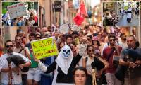 Thousands of anti-tourism protesters take to the streets of Majorca, with some waving anti-English banners