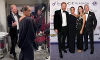Meghan 'shapeshifts from childlike to confident' at event to support music mogul pal David Foster as she 'coyly' holds onto Harry in candid clip before switching to photo-ready 'regal mode', body language expert claims