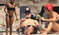 Rita Ora sizzles in a strapless black bikini as she enjoys a cigarette with her husband Taika Waititi during sun-soaked yacht day in Ibiza