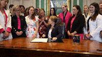 Applause erupts as Democratic governor signs law allowing abortion up to birth