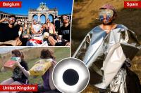 Europeans take in rare total eclipse as sunny holiday hotspots briefly turn to darkness: photos