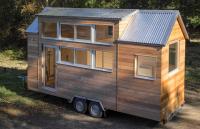 Custom tiny home in France fits a full kitchen, office, and storage into one calm space