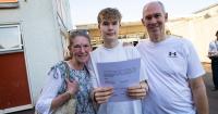 Students celebrating on results day with States pass rate up