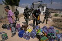 Activists try to deliver supplies to Palestinians besieged by Israeli settlers in West Bank