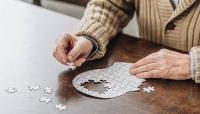 Why does the brain become more vulnerable to Alzheimer's disease with age?