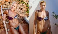Rita Ora poses in a patterned bikini as she takes an outdoor shower ahead of performing at the Bittersweet Music Festival in Poland