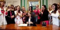 Women Laugh and Applaud as Massachusetts Governor Signs the “Kill Your Baby Anytime” Legislation
