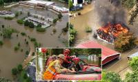 Six dead, including 4-year-old boy, as hundreds rescued in 'once-in-a-lifetime floods' in Indiana as raging waters engulf homes and threaten to swallow towns