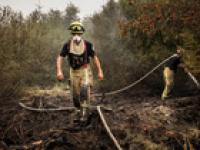 Firefighters battle wildfires in Belgium and Greece as 2 die on island near Athens