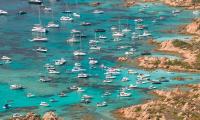 Sardinian coastal beauty spots are overrun by 'locust swarm' of tourist party boats sparking fury among conservationists