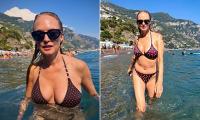 Heather Graham, 56, showcases her incredible figure in a maroon bikini as she frolics in the sea during sun-soaked Italian getaway