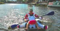Inflatable cow paddler now going upriver and invites others to join challenge