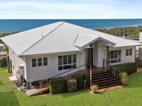 K’gari house smashes sale record as six bidders battle for island property.